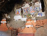 Mustang 02 07-3 Rangbyung Cave Painted Chortens The main images in the Rangbyung cave gompa are the painted chortens of Shakyamuni Buddha, Guru Rinpoche (Padmasambhava), Amitabha, and Avolokiteshvara.